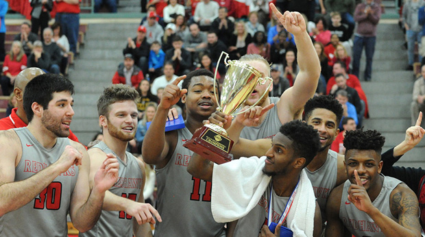 Members of the La Roche men's basketball team hold their championship trophy after defeating Penn State Behrend 77-74.